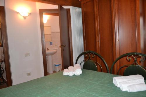 a green table with two chairs and two pairs of slippers at Agriturismo Montorso in Monte Rinaldo