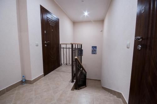 um corredor com uma porta de madeira e uma escada em Wonderful flat on city center (Mukachivska 4/11) em Uzhhorod