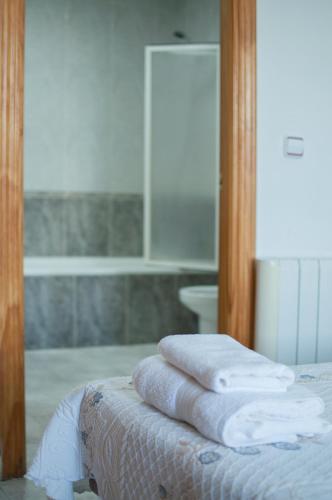 a pile of towels sitting on top of a bed at Hostal Concepción in La Mata