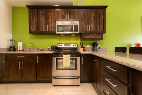 a kitchen with a stove and a microwave at Cabo Velas Estates 30 in Matapalo
