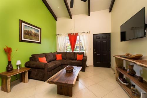 a living room with a couch and a tv at Cabo Velas Estates 30 in Matapalo