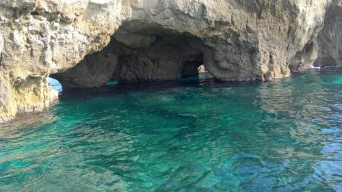 a cave in the middle of the water at Acquarium Tropea in Tropea