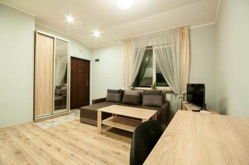 una sala de estar con un sofá y una mesa en Wonderful flat on city center (Mukachivska 4/18), en Uzhhorod