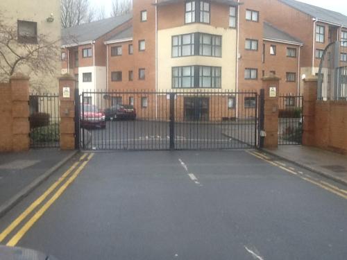 a driveway with a gate in front of a building at Liverpool 2 Bedroom Apartment in Liverpool