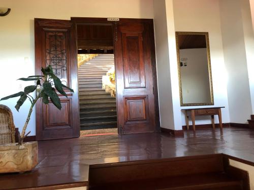 a hallway with a staircase and a door with a mirror at Pousada Encanto de Búzios in Búzios