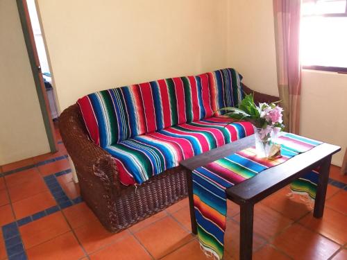 a living room with a couch and a table at Reef View Pavilions - Villas & Condos in Lance aux Épines