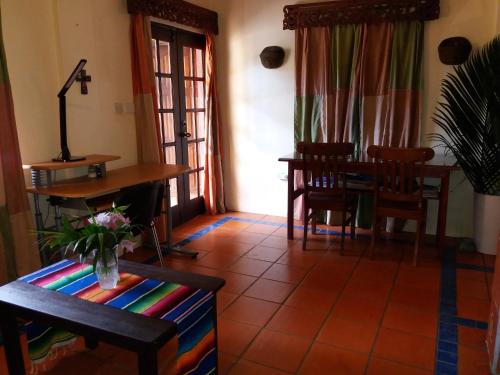 a living room with a dining room table and chairs at Reef View Pavilions - Villas & Condos in Lance aux Épines