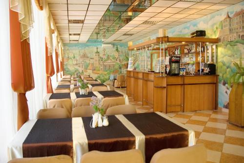 a row of tables and chairs in a restaurant at Galitsiya Hotel in Lviv