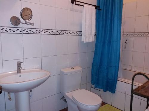 a bathroom with a toilet and a sink at Reef View Pavilions - Villas & Condos in Lance aux Épines