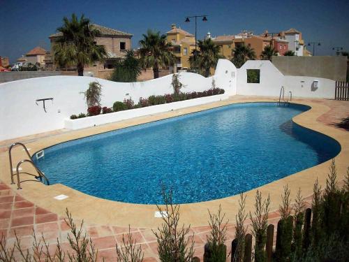 a large swimming pool in a yard with a house at Cadiz Golf in Sanlúcar de Barrameda