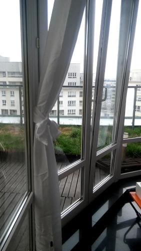 a window with a white curtain in a room at Walk distance to mokotow business park in Warsaw