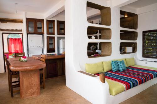 a living room with a couch and a table at Reef View Pavilions - Villas & Condos in Lance aux Épines