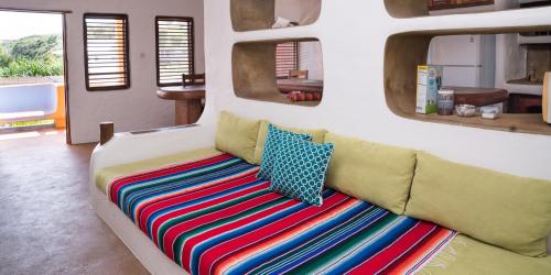 a couch in a room with two mirrors at Reef View Pavilions - Villas & Condos in Lance aux Épines