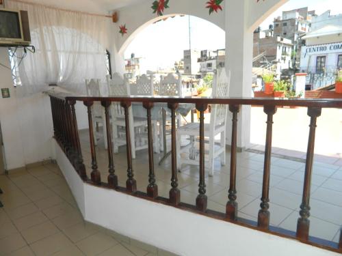 a balcony with a railing with a view of a city at Posada Joan Sebastian in Taxco de Alarcón