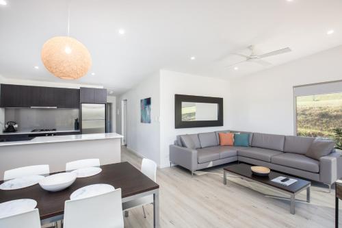 a living room with a couch and a table at Blue Lake Holiday Park in Mount Gambier