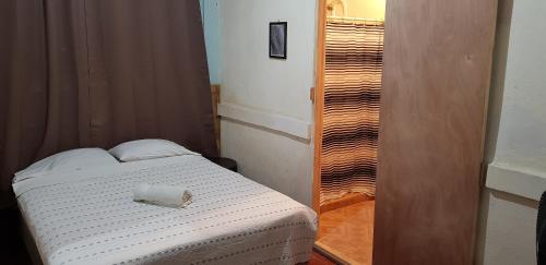 a bedroom with a bed with a towel on it at Playa Roca Beach Hotel in Las Peñitas