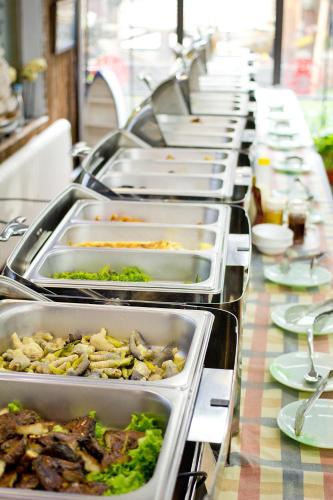 a long buffet line of trays of food at MG Hotel St Michael's Cathedral, Qingdao in Qingdao