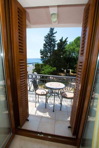 a view of a balcony with a table and chairs at Apartments Villa Castello in Crikvenica
