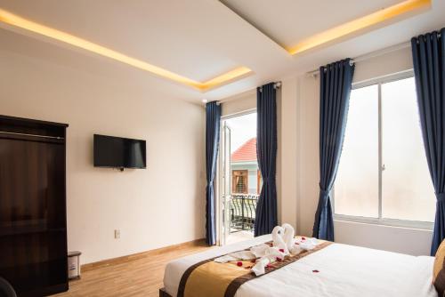 a hotel room with a bed and a window at Silver Moon Hotel Hoi An in Hoi An