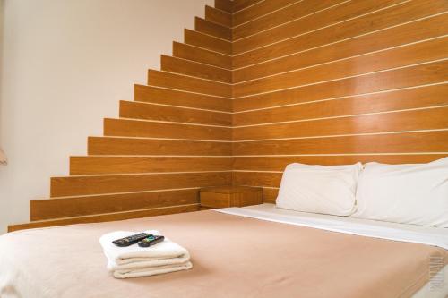 a bedroom with a bed with towels on it at Noble U-house Chiangmai in Chiang Mai