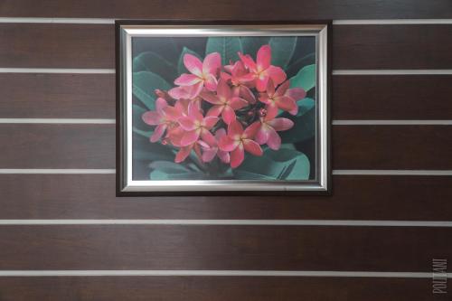 a painting of a pink flower on a wall at Noble U-house Chiangmai in Chiang Mai