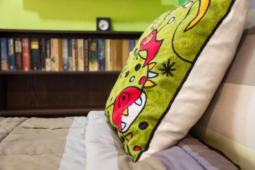 a tie sitting on top of a bed at Rice Barn And Rooms in Hang Dong