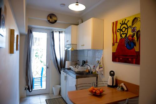a kitchen with a sink and a table with oranges on it at Patras Centre Apartment in Patra
