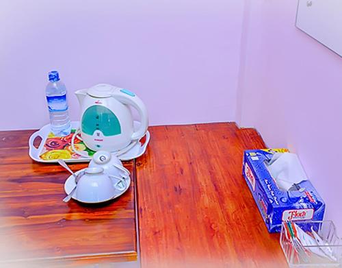 a table with a tea pot and a bottle of water at Villu Villa in Anuradhapura