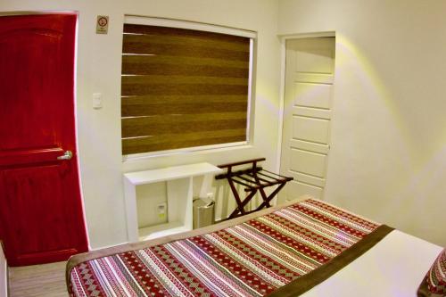 a bedroom with a window and a bed with a rug at Yakana Hotel in San Pedro de Atacama
