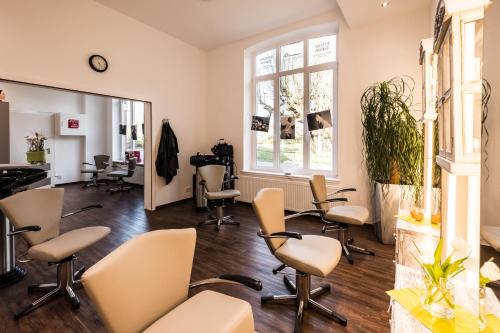 a salon with chairs and a mirror at Das 53°Hotel in Bad Zwischenahn