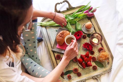a woman sitting at a table with a tray of food at Torre Di Vico Residenza D'Epoca in Viterbo