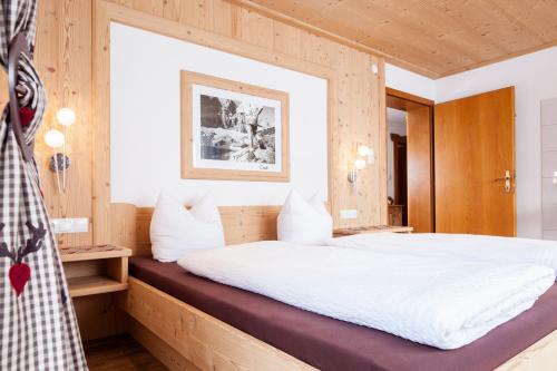 a bedroom with a large white bed in a room at Apart Tyrol in Uderns