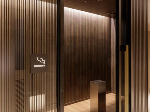 a sliding glass door with a toilet sign on it at Art Hotel Osaka Bay Tower in Osaka
