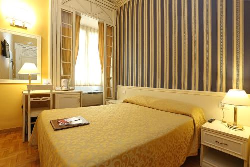 um quarto de hotel com uma cama com um livro em DG Prestige Room em Roma