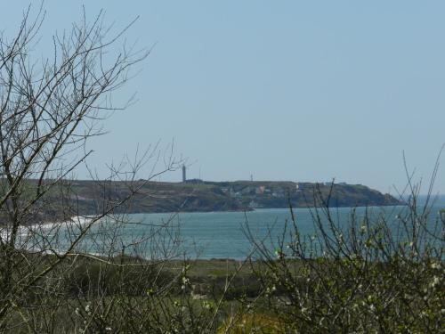 a view of a body of water from a field at Hôtel Le Vivier WISSANT - Vue Mer - Côte d'Opale - Baie de Wissant - 2CAPS in Wissant
