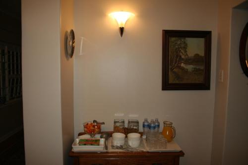 a room with a table with a light on the wall at brookdale house in Cape Town