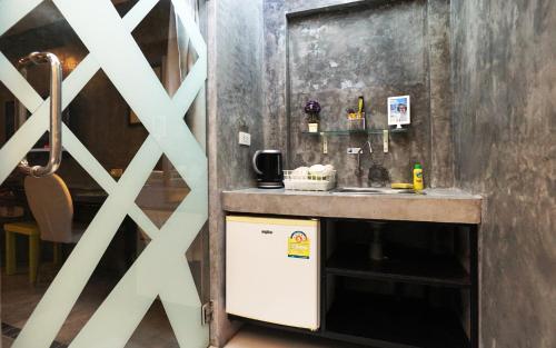 a kitchen with a counter and a sink in a room at Phuket Paradiso in Chalong 