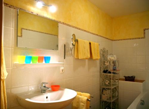 a bathroom with a sink and a mirror at Amadeus Appartement in Sankt Johann in Tirol