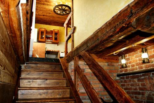 a staircase in a room with wooden walls and ceilings at City Center Apartments in Poltava