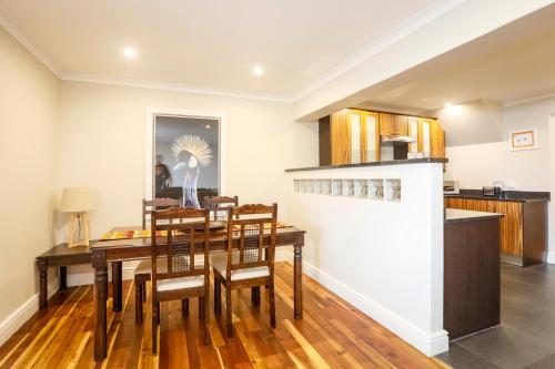 a kitchen and dining room with a table and chairs at Orange Inn Knysna in Knysna