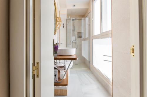 a bathroom with a sink and a window at Hotel Casa de las Cuatro Torres in Cádiz