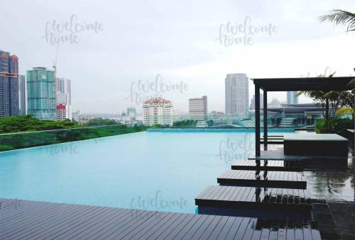 a swimming pool with a view of the city at Paragon Suites CIQ Homestay by WELCOME HOME in Johor Bahru