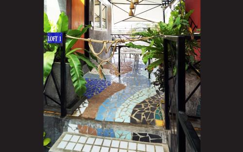 a tiled floor with a patio with plants at Phuket Paradiso in Chalong 