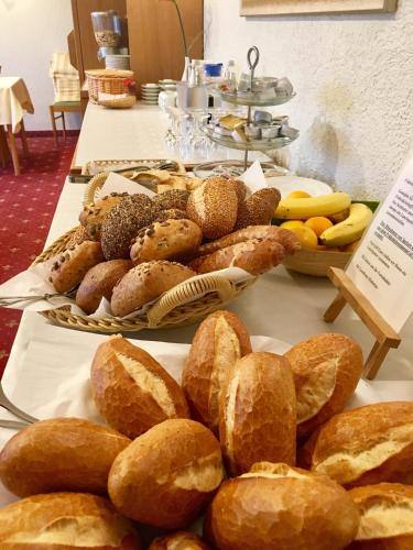a bunch of bread and pastries on a table at Landhotel Hubertus in Unterelsbach