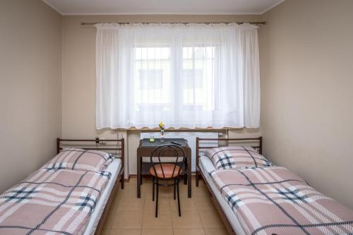 Tempat tidur dalam kamar di Pokoje Gościnne Arkadia