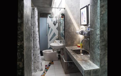 a small bathroom with a sink and a toilet at Phuket Paradiso in Chalong 