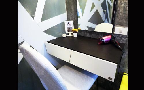 a black and white desk with a white chair in a room at Phuket Paradiso in Chalong 
