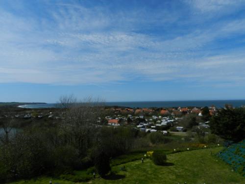 a view of a town with the ocean in the background at Hôtel Le Vivier WISSANT - Vue Mer - Côte d'Opale - Baie de Wissant - 2CAPS in Wissant