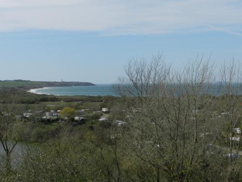 a view of the ocean from a hill with trees at Hôtel Le Vivier WISSANT - Vue Mer - Côte d'Opale - Baie de Wissant - 2CAPS in Wissant