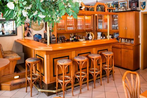 a kitchen with a bar with stools at Hotel-Pension Hafemann in Senftenberg